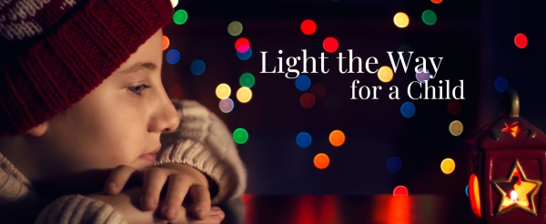 Child looking at a Christmas ornament