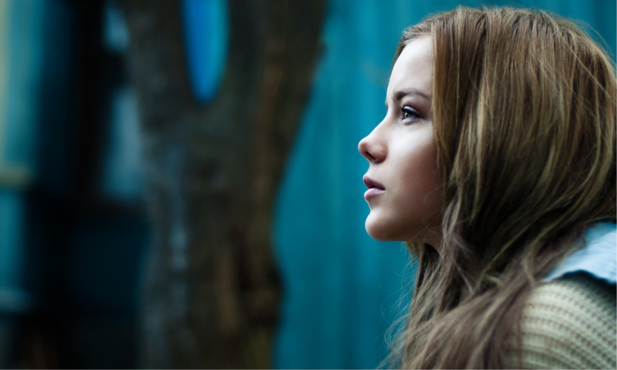 A young pensive woman outdoors