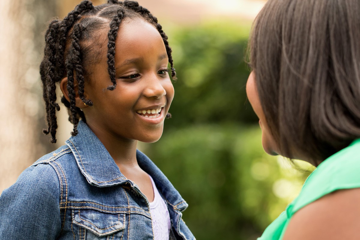 Two children talking to each other outdoors