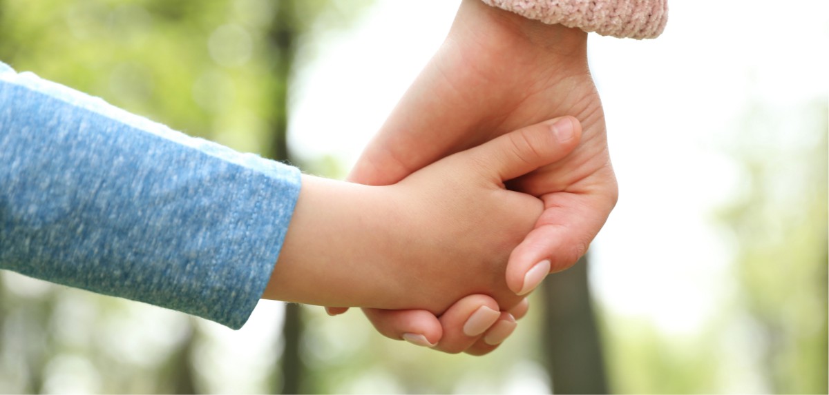 A child and an adult hand holding hands