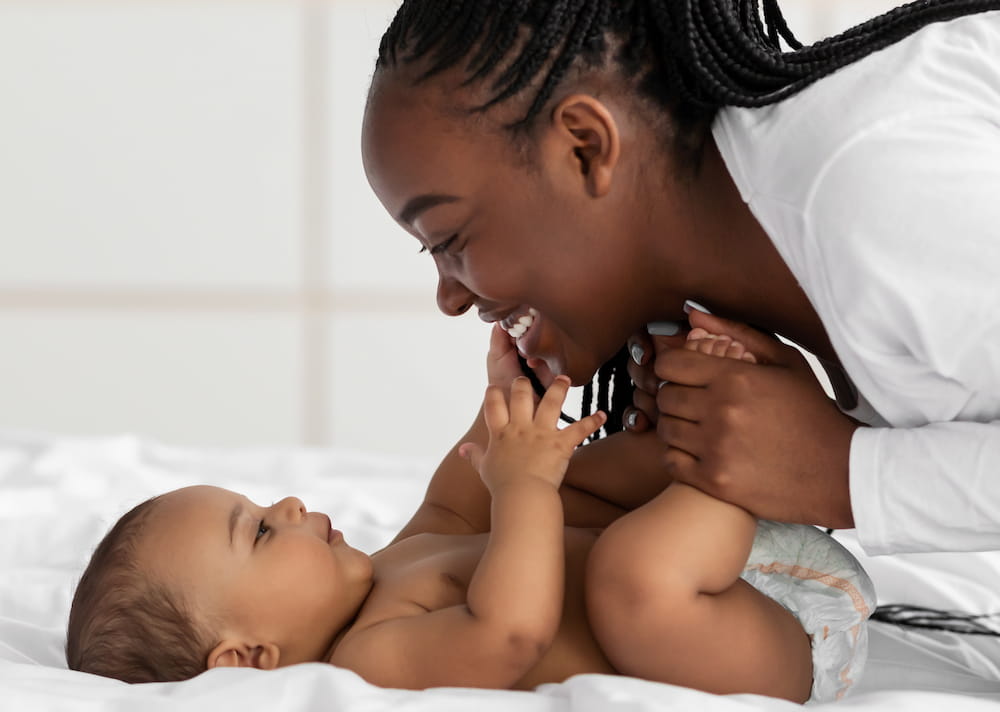 A mother playing with her baby