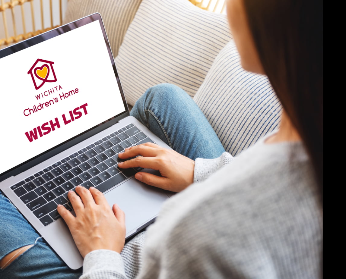 A woman searching Wichita Children's Home wish list items on her laptop