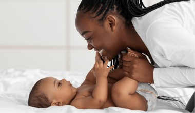 A mother playing with her baby